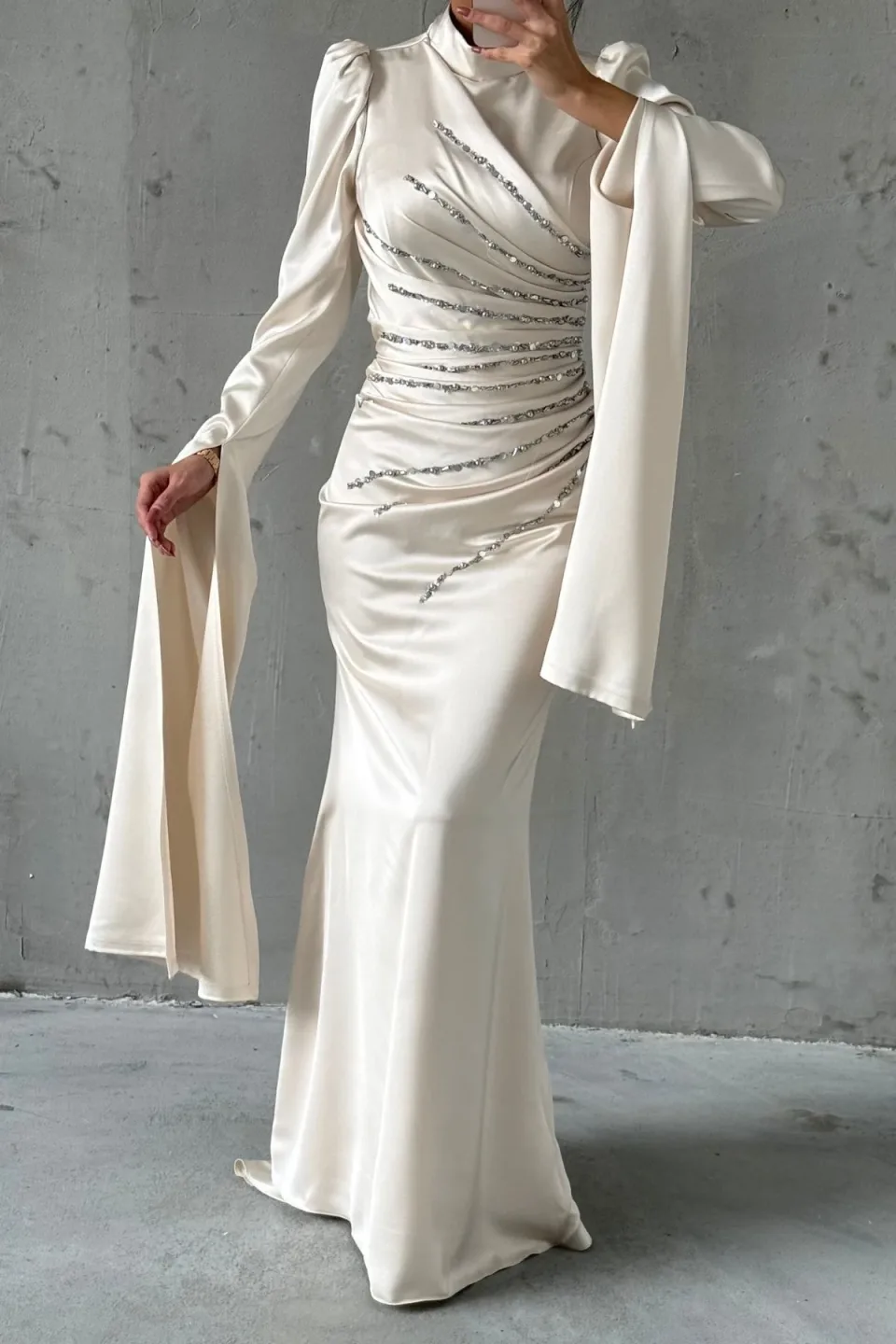 Embellished, draped gown with a sophisticated silhouette.